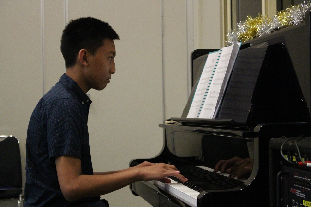 Student practigin piano lesson