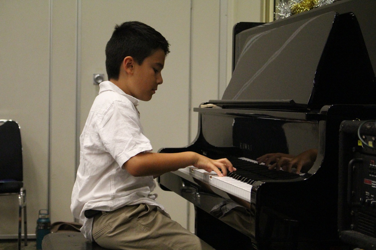 Student practigin piano lesson